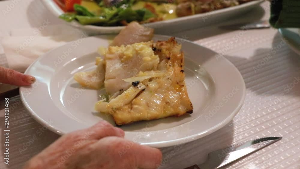 cod fish with vegetables in white dish in restaurant cod fish with vegetables in white dish in restaurant