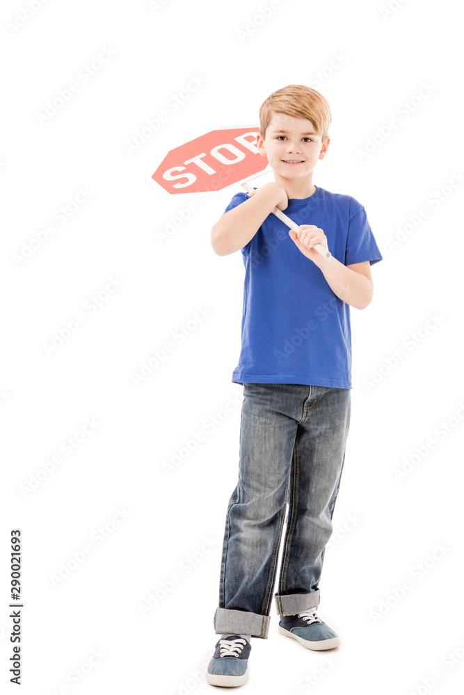 full length view of smiling boy holding stop sign isolated on white full length view of smiling boy holding stop sign isolated on white