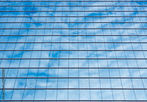 Architecture details Modern Building Glass facade steel pattern Reflection blue sky