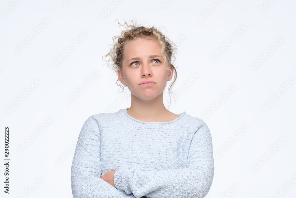 Beautiful pensive woman in studio looking up trying to make a right decision. Studio shot Beautiful pensive woman in studio looking up trying to make a right decision. Studio shot