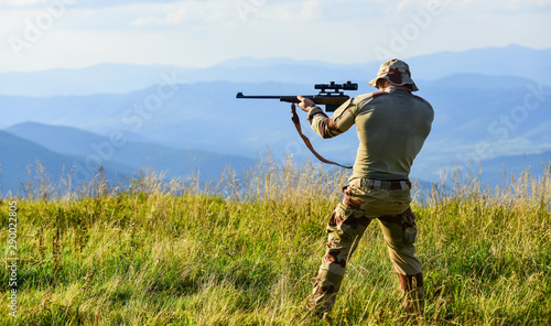 Nice shot. Army forces. Hunter hold rifle. Hunter mountains landscape background. Focus and concentration experienced hunter. Man military clothes with weapon. Brutal warrior. Rifle for hunting