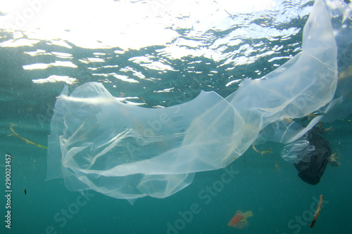 Plastic pollution in ocean. Plastic bags, bottles and straws dumped in sea 