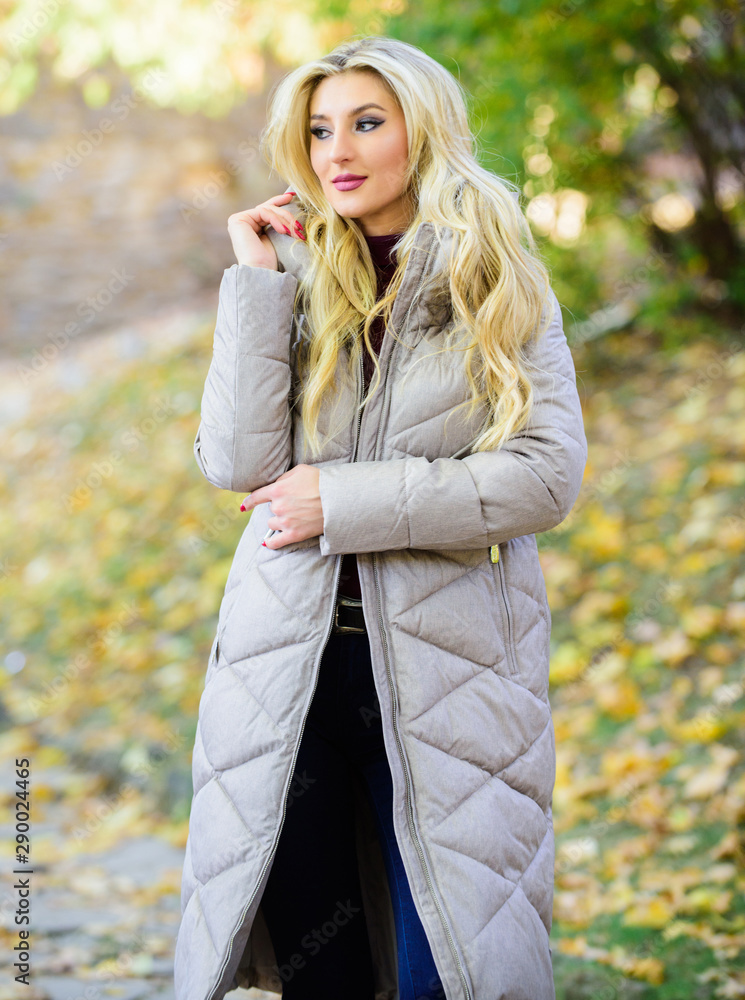 Woman wear warm grey jacket. Jacket everyone should have. Puffer fashion trend concept. Oversized jacket trend. Puffer jacket casual and comfortable style. Girl fashionable blonde walk in autumn park Woman wear warm grey jacket. Jacket everyone should have. Puffer fashion trend concept. Oversized jacket trend. Puffer jacket casual and comfortable style. Girl fashionable blonde walk in autumn park