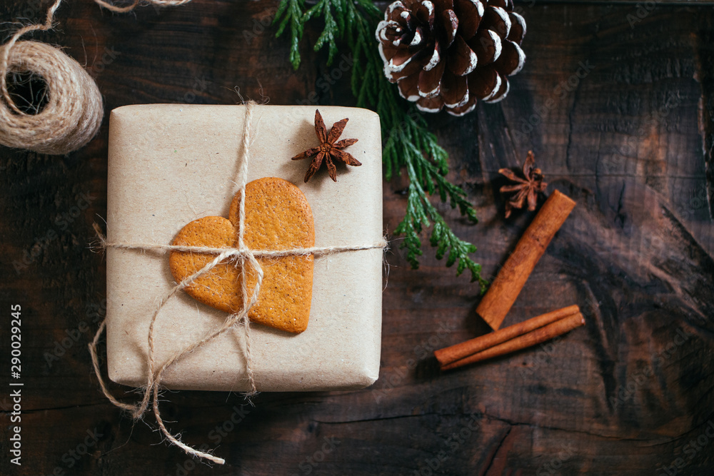 Fotografie Rustic Christmmas present with gingerbread cookie