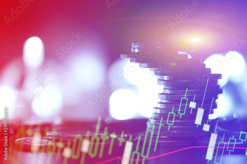 Financial investment concept  Double exposure of city night and stack of coins for finance investor  Forex trading candlestick chart economic   ECN Digital economy  business.