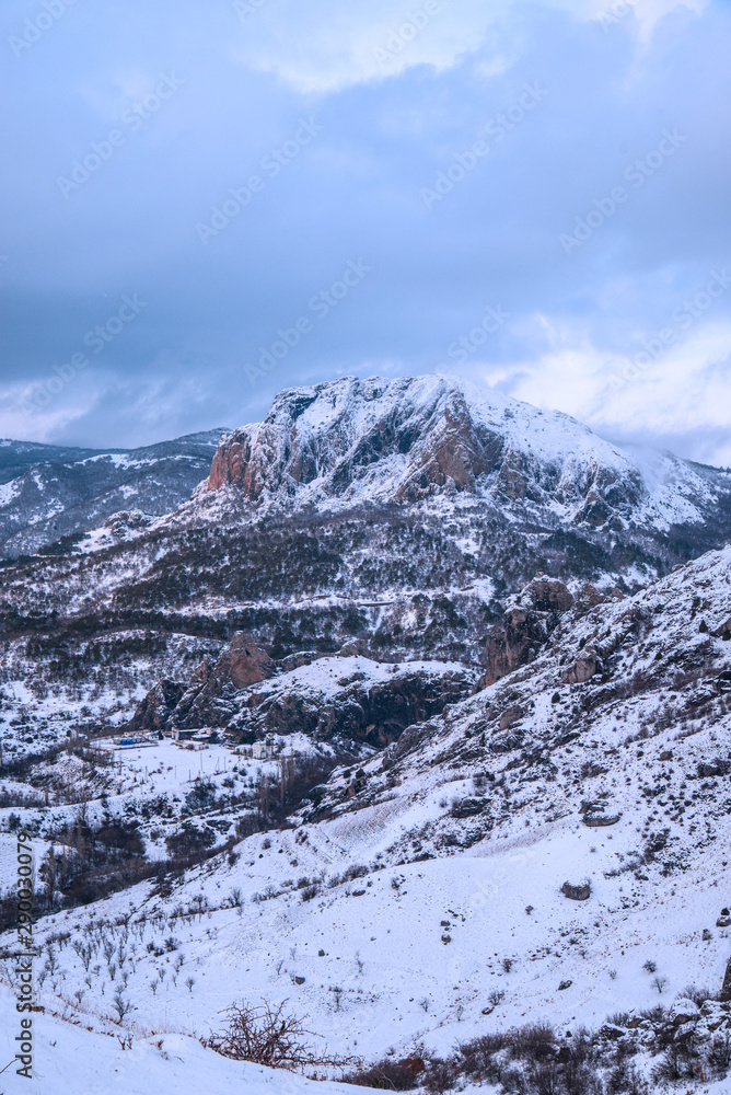 Rocky peak in winter mountains