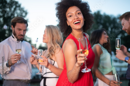 Group of friends at party dancing and smiling together