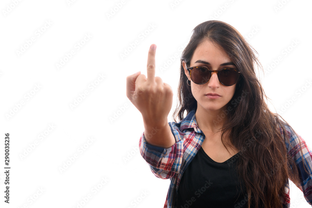 Caucasian young girl with plaid shirt and sunglasses say no with her finger and serious face. Caucasian young girl with plaid shirt and sunglasses say no with her finger and serious face.