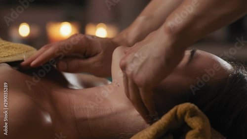 Wallpaper Mural CU Relaxed woman receiving face massage with candles at background. Young woman came in spa center for anti-agin or face lifting massage. Close-up of relaxed woman with closed eyes at spa salon. 4k Torontodigital.ca