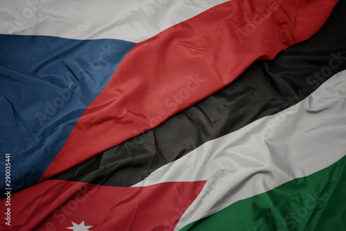 waving colorful flag of jordan and national flag of czech republic.