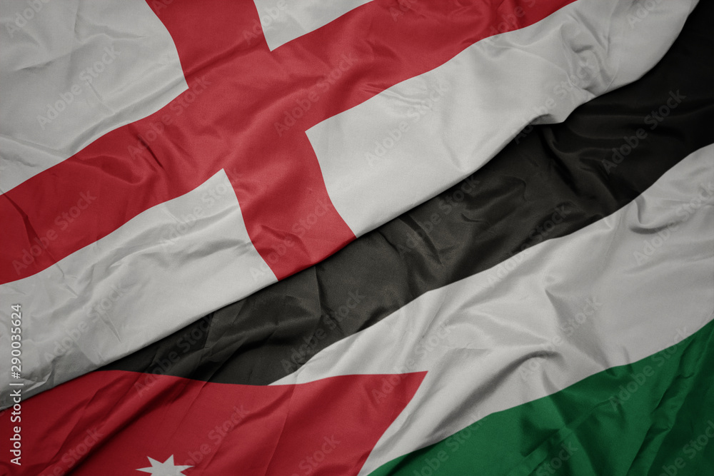 waving colorful flag of jordan and national flag of england.