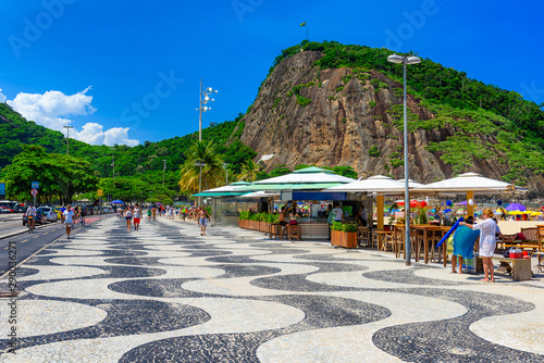 View of Copacabana beach and Leme beach with palms and mosaic of sidewalk in Rio de Janeiro, Brazil photo