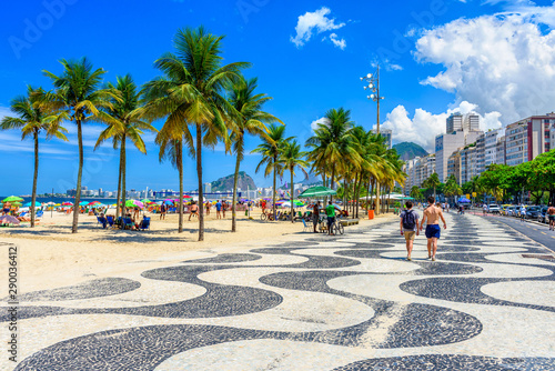 View of Copacabana beach and Leme beach with palms and mosaic of sidewalk in Rio de Janeiro, Brazil