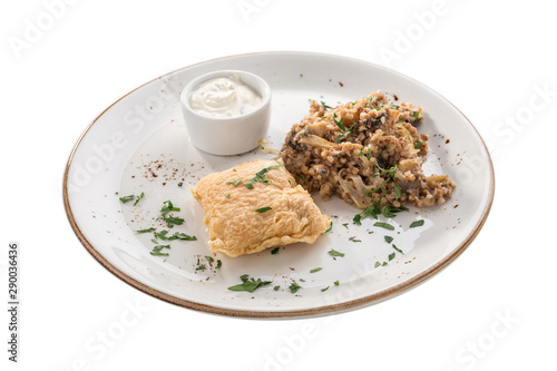 deep fried fish fillet in batter with buckwheat with mushroom and white sauce isolated on white background