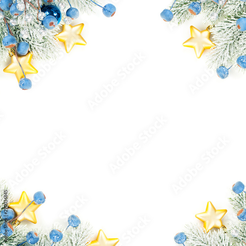 Christmas composition corner top view. Colorful winter background with green Xmas tree twig, blue decoration and gold stars isolated on white background