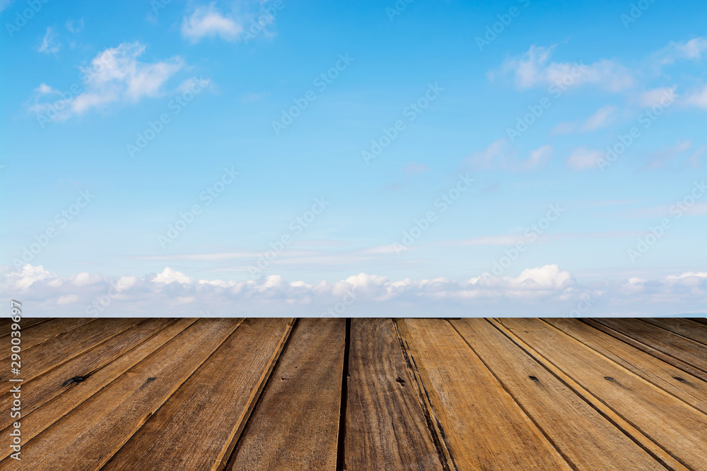 blue sky with clouds and wood background