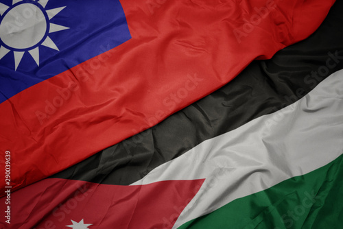 waving colorful flag of jordan and national flag of taiwan.