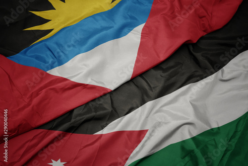 waving colorful flag of jordan and national flag of antigua and barbuda.