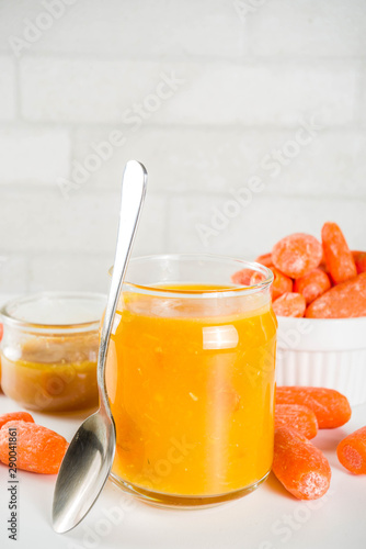 Homemade carrot jam with fresh baby carrots, copy space