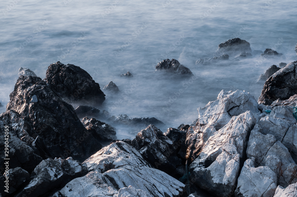 Beautiful stones, rocks and sea in a mystical haze at sunset. Long exposure. cool light landscape. Turkey. Aegean sea shore. Beautiful stones, rocks and sea in a mystical haze at sunset. Long exposure. cool light landscape. Turkey. Aegean sea shore.
