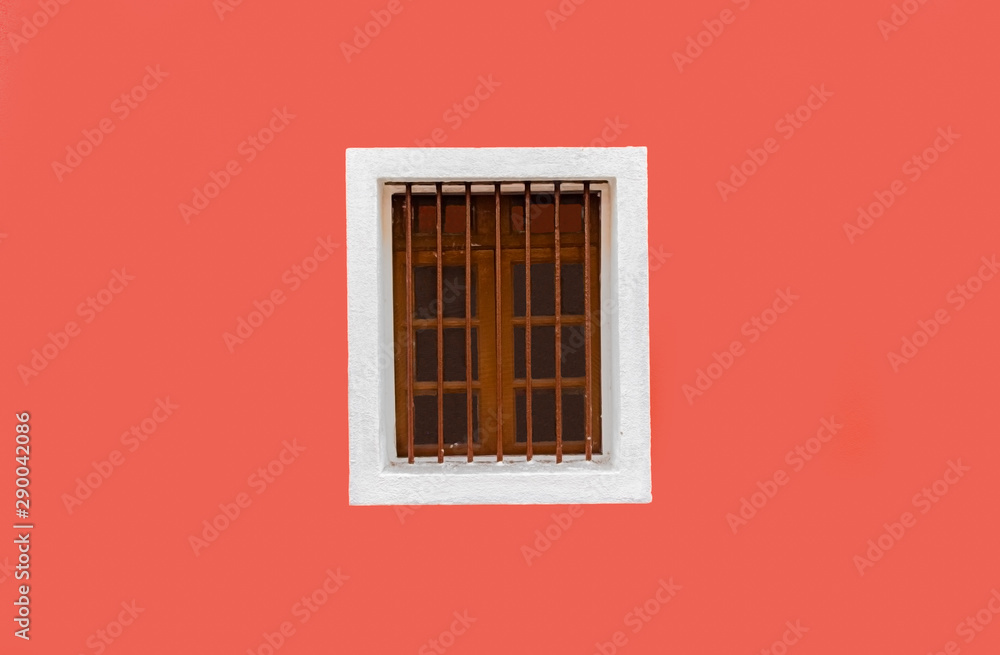 Beautiful background photo of Exterior wall, painted fresh with solid color of peach. The wall is clean, plain and a Vintage Wooden Window with white outline is adding further glam. -Image Beautiful background photo of Exterior wall, painted fresh with solid color of peach. The wall is clean, plain and a Vintage Wooden Window with white outline is adding further glam. -Image
