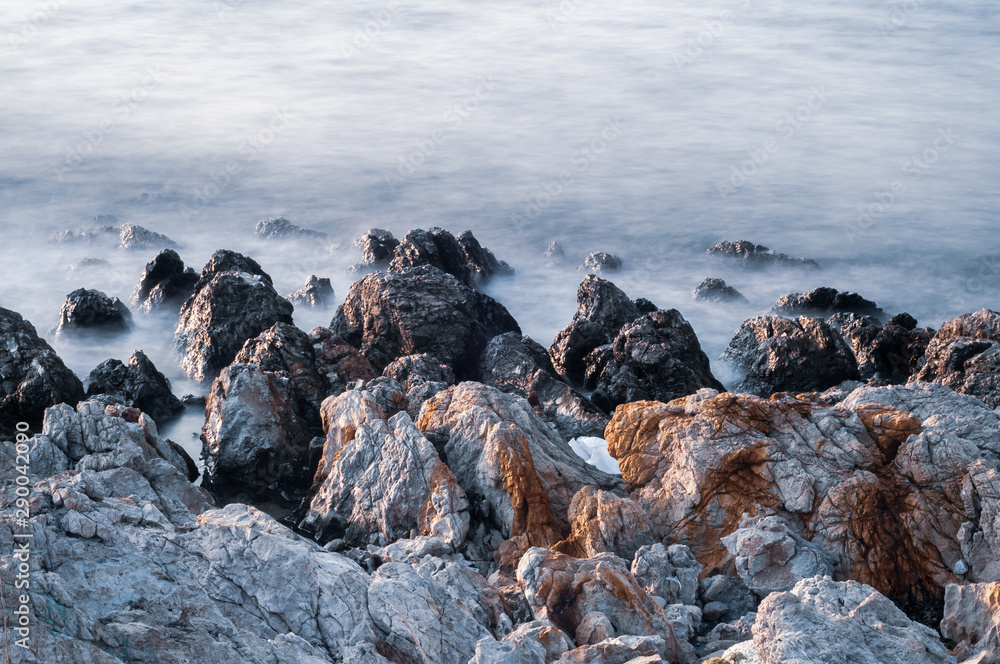 Beautiful stones, rocks and sea in a mystical haze at sunset. Long exposure. cool light landscape. Turkey. Aegean sea shore. Beautiful stones, rocks and sea in a mystical haze at sunset. Long exposure. cool light landscape. Turkey. Aegean sea shore.