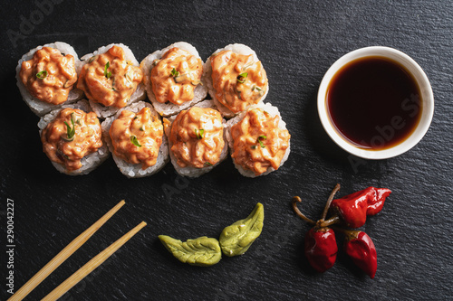 Asian meal on stone plate on black background