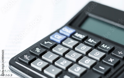 Calculator on white paper with numbers. Business and Finance accounting concept.