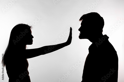 Bilde på lerret Man abusing woman, silhouette on a white background