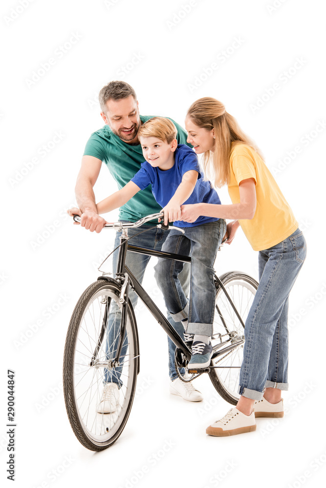full length view of smiling parents teaching son to ride bike isolated on white full length view of smiling parents teaching son to ride bike isolated on white
