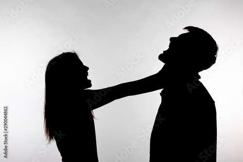 Domestic violence and abuse concept - Silhouette of a woman asphyxiating a man