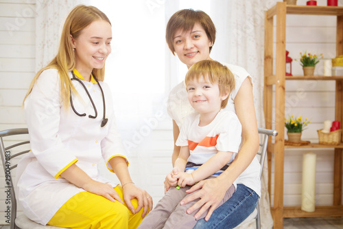 Pediatrist examinate young patient's lungs with stethoscope photo