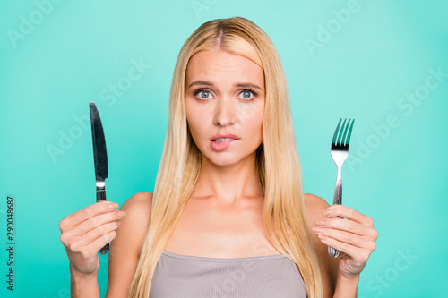 Close-up portrait of her she nice attractive moody unsatisfied straight-haired girl holding in hand kitchen ware waiting service delivery isolated on bright vivid shine green blue turquoise background