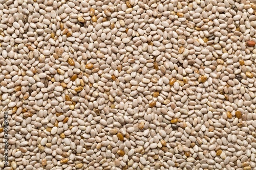 Whole, organic white chia seeds texture top view from above