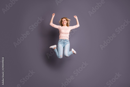Full size photo of pretty lady jumping high competitive mood cheerleading wear casual stylish outfit isolated grey color background