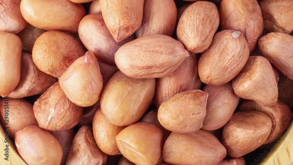 panning peanuts in wood bowl isolated on white background. top view panning peanuts in wood bowl isolated on white background. top view