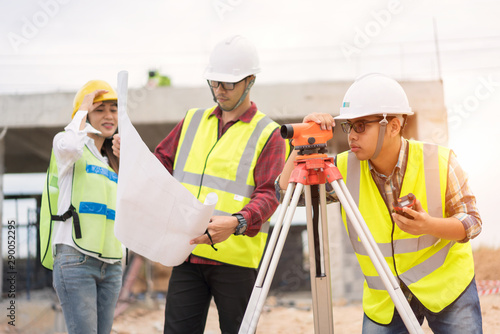 Engineer surveyor working with theodolite at construction site © Aunging