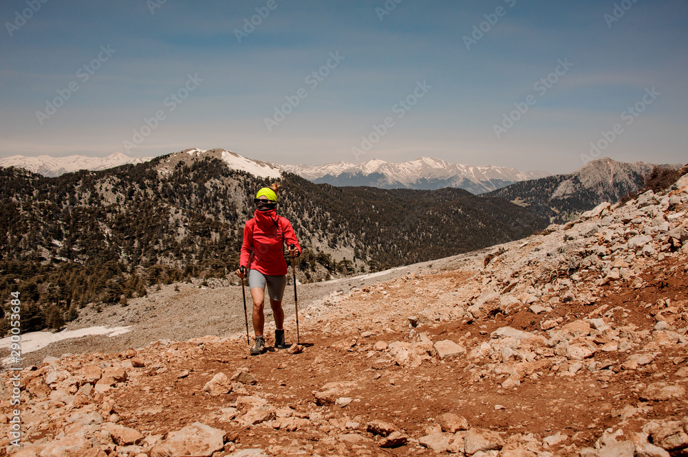 Sporty girl walking on the rock road on the Tahtali mountain with hiking backpack
