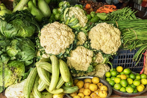 Some vegetables, like as cauliflower, cabbage, kale, carrots, zucchini, limes in a farmers market.