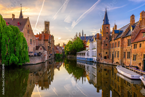 Classic view of the historic city center of Bruges (Brugge), West Flanders province, Belgium. Sunset cityscape of Bruges. Canals of Brugge photo