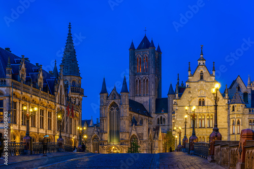 Medieval city of Gent (Ghent) in Flanders with Saint Nicholas Church and Gent Town Hall, Belgium. Nigth cityscape of Gent.