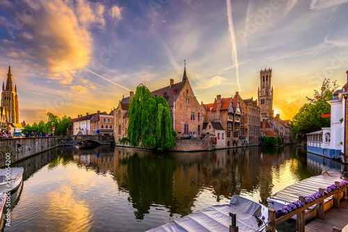 Classic view of the historic city center of Bruges (Brugge), West Flanders province, Belgium. Sunset cityscape of Bruges. Canals of Brugge