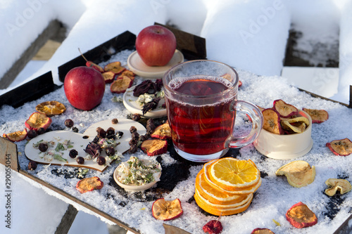New Year or Christmas flat lay top view with Hot red tea with different herb, fresh and dry fruit and berry