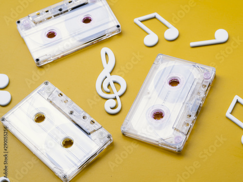 Diagonal view white cassette tapes with musical notes around