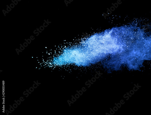 Blue powder explosion on black background.