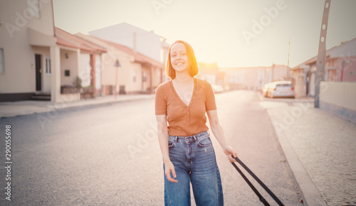 Portrait of 20 years old beautiful happy cute young girl hipsetr on sunny street in the city