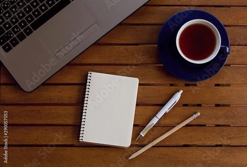 Office desk table with laptop computer, cup and all important properties