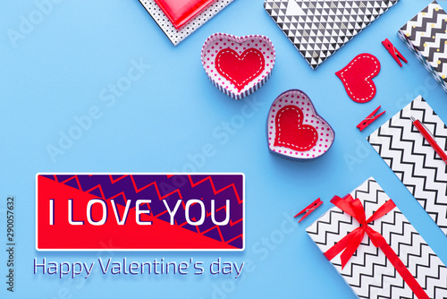 Person holding a present for Saint Valentine's day in his hands. Beautiful colorful background to st. Valentine day. Greeting card with red hearts. Wedding's invitation. Love expression.