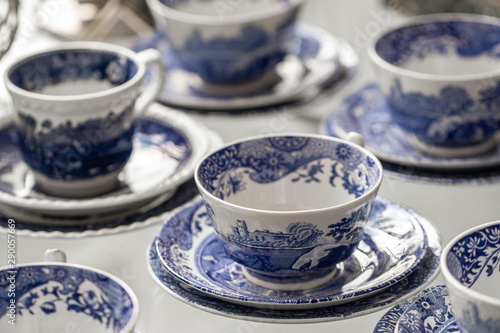 Ceramic  blue and white tea cups on white table background.