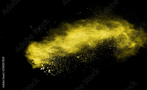 Yellow powder explosion on black background.